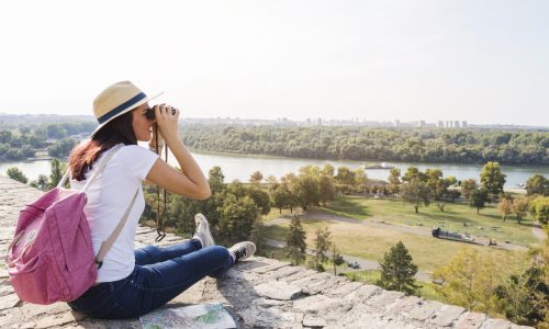 female-hiker-looking-view-through-binoculars-scaled.jpg