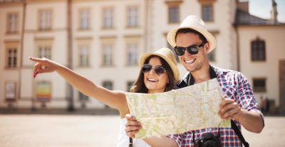 happy-tourist-sightseeing-city-with-map-scaled.jpg