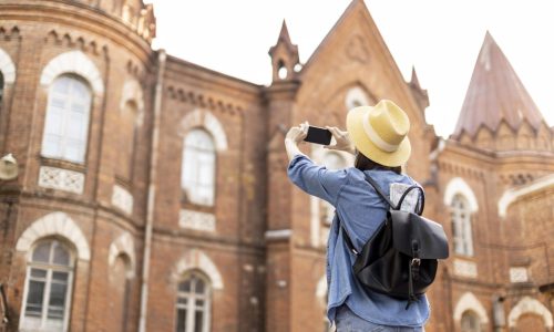 stylish-traveller-with-hat-taking-pictures-holiday-scaled.jpg