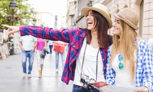 woman-showing-something-her-happy-female-friends-holding-map-scaled.jpg