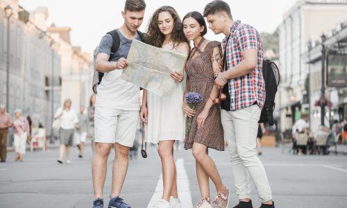 young-people-standing-street-discovering-city-map-scaled.jpg